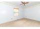 Carpeted bedroom with neutral walls, wood trim, and ceiling fan at 391 W 500 S, Anderson, IN 46013