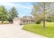 Inviting home with a charming yard, mature trees, and an attached garage offering both beauty and functionality at 391 W 500 S, Anderson, IN 46013