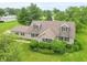 Aerial view of a charming home with dormer windows, a welcoming front porch, and neatly manicured landscaping at 391 W 500 S, Anderson, IN 46013