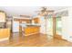 Traditional eat-in kitchen with wood cabinets, laminate counters, ceiling fan, and sliding glass door at 391 W 500 S, Anderson, IN 46013