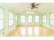 Bright sunroom with lots of natural light, multiple windows, and a ceiling fan at 391 W 500 S, Anderson, IN 46013