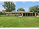 View of the house from the backyard showing the yard, sunroom, and brick exterior at 406 W Mcgregor Rd, Indianapolis, IN 46217