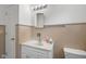 The bathroom features a white vanity with sink, a well-lit mirror, and ceramic tile surround at 406 W Mcgregor Rd, Indianapolis, IN 46217