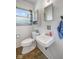 Bright bathroom with a modern toilet, white sink and cabinet, and blue patterned curtain at 406 W Mcgregor Rd, Indianapolis, IN 46217
