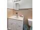 A bathroom featuring a white vanity with sink, ceramic tile surround, and mirrored medicine cabinet at 406 W Mcgregor Rd, Indianapolis, IN 46217