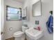 The bathroom has a vintage-look sink, mirror and cabinet at 406 W Mcgregor Rd, Indianapolis, IN 46217