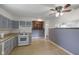 Traditional kitchen features tile floors, white appliances, and blue cabinets at 406 W Mcgregor Rd, Indianapolis, IN 46217
