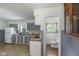 Traditional kitchen features blue cabinets and a view into the adjacent bathroom at 406 W Mcgregor Rd, Indianapolis, IN 46217