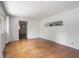 Bright living room features hardwood floors, and neutral paint, with an open view into the next room at 406 W Mcgregor Rd, Indianapolis, IN 46217