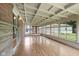 The sunroom features a wood floor, beamed ceiling, and multiple windows providing lots of natural light at 406 W Mcgregor Rd, Indianapolis, IN 46217