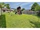 Backyard with play set and lush green lawn at 419 N 14Th Ave, Beech Grove, IN 46107