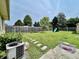 Expansive backyard with a wooden fence, stone pathway, playset, and lush lawn at 419 N 14Th Ave, Beech Grove, IN 46107
