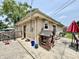 A brick home featuring a back door and a playhouse in a concrete backyard at 419 N 14Th Ave, Beech Grove, IN 46107
