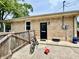 The back of a brick home with a black door, a black bike and a red wagon at 419 N 14Th Ave, Beech Grove, IN 46107