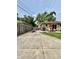 A concrete patio in the backyard with a red umbrella and a fire pit with seating at 419 N 14Th Ave, Beech Grove, IN 46107