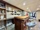 Basement bar with custom wood countertop and bar stool seating at 419 N 14Th Ave, Beech Grove, IN 46107