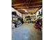 Basement area featuring concrete floor, open ceiling, storage shelves, and a small Christmas tree at 419 N 14Th Ave, Beech Grove, IN 46107