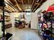 Basement area featuring concrete floor, open ceiling, storage shelves, and door at 419 N 14Th Ave, Beech Grove, IN 46107