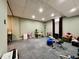 Large basement room with neutral carpeting, scattered toys, and recessed lighting, creating a flexible space at 419 N 14Th Ave, Beech Grove, IN 46107