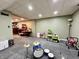 Carpeted basement features a drum set and a glimpse of a bar area in the adjacent room at 419 N 14Th Ave, Beech Grove, IN 46107