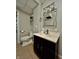 Bathroom featuring tile flooring, vanity with cabinet, mirror, toilet, and shelves at 419 N 14Th Ave, Beech Grove, IN 46107