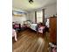 Bedroom features hardwood floors, neutral paint, and a cozy atmosphere at 419 N 14Th Ave, Beech Grove, IN 46107