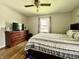 Bedroom with wood floors, neutral paint, a ceiling fan, and a large dresser at 419 N 14Th Ave, Beech Grove, IN 46107
