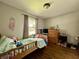 Bright bedroom featuring hardwood floors, neutral paint, and a cozy atmosphere at 419 N 14Th Ave, Beech Grove, IN 46107