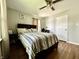Cozy bedroom features wood floors, ceiling fan, and updated neutral paint at 419 N 14Th Ave, Beech Grove, IN 46107