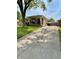Charming single-story home with a long driveway and well-maintained landscaping at 419 N 14Th Ave, Beech Grove, IN 46107