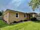Well-maintained brick home with manicured lawn, dark mulched flowerbeds, and charming front porch at 419 N 14Th Ave, Beech Grove, IN 46107