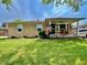 Well-kept single-story home with attractive landscaping and an American flag at 419 N 14Th Ave, Beech Grove, IN 46107