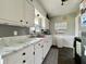 Classic kitchen features white cabinets, marble countertops, stainless steel appliances, and modern fixtures at 419 N 14Th Ave, Beech Grove, IN 46107