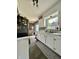 Traditional kitchen with white cabinetry, a gray accent rug, a tile floor and an eat-in breakfast nook at 419 N 14Th Ave, Beech Grove, IN 46107