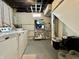 Laundry area in basement featuring washer, dryer, wire rack for storage, and stairs at 419 N 14Th Ave, Beech Grove, IN 46107