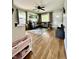 Open living room with hardwood floors, gray sectional sofa, and a view to the entry door at 419 N 14Th Ave, Beech Grove, IN 46107