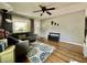 The bright living room includes hardwood floors, gray couch, and entry and sliding glass doors in view at 419 N 14Th Ave, Beech Grove, IN 46107