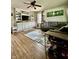 Inviting living room featuring hardwood floors, a comfortable gray sectional, and a ceiling fan at 419 N 14Th Ave, Beech Grove, IN 46107