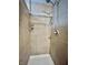 Shower stall featuring white shower pan and tile walls, with adjustable shower head at 419 N 14Th Ave, Beech Grove, IN 46107