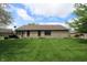 Expansive backyard and exterior of brick home, including the lawn, grill, and screened porch at 421 Kingsway Ct, Mooresville, IN 46158