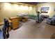 Finished basement with work area, storage, lounge seating, and exercise machine at 421 Kingsway Ct, Mooresville, IN 46158