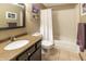 Bright bathroom features granite vanity, framed mirror, and tiled shower with white curtain at 421 Kingsway Ct, Mooresville, IN 46158