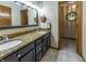 Stylish bathroom with dual sinks, granite countertops, and dark wood cabinets at 421 Kingsway Ct, Mooresville, IN 46158
