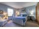 Cozy bedroom with a plush bed, soft lighting, and light blue walls at 421 Kingsway Ct, Mooresville, IN 46158