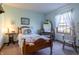 Inviting bedroom with quaint furnishings, natural light, and colorful decorative quilt at 421 Kingsway Ct, Mooresville, IN 46158