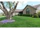 Beautiful home exterior with manicured lawn, mature tree, and colorful flowerbeds in front yard at 421 Kingsway Ct, Mooresville, IN 46158