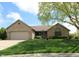 Charming brick ranch home with well-manicured lawn, mature trees, and two car garage at 421 Kingsway Ct, Mooresville, IN 46158