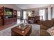 Inviting living room with a beautiful hardwood floor, entertainment center, and bright natural light at 421 Kingsway Ct, Mooresville, IN 46158