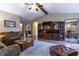Comfortable living room featuring hardwood floors, ceiling fan, and entertainment center at 421 Kingsway Ct, Mooresville, IN 46158