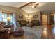 Cozy living room featuring high ceilings, ceiling fan, hardwood floors, and comfortable seating at 421 Kingsway Ct, Mooresville, IN 46158